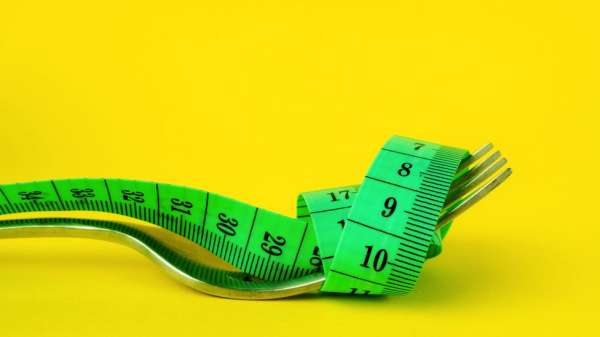 Tape measure wrapped around a fork
