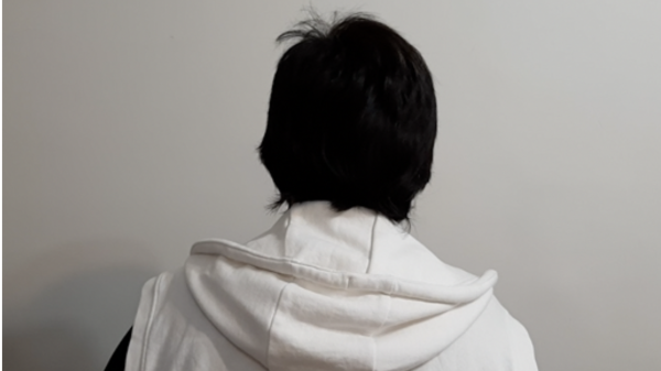 Zara has had to hide her identity so faces a white wall