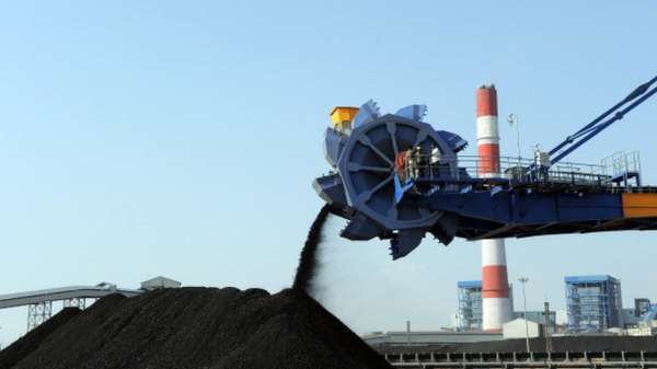 Workers use heavy machinery to sift through coal at the Adani Power company thermal power plant at Mundra some 400 kms from Ahmedabad on February 18, 2011.