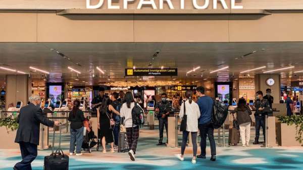 Travellers arrive at the departure hall in Singapore Changi airport in Singapore on March 31, 2023.