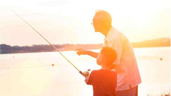 A boy and his grandfather fishing